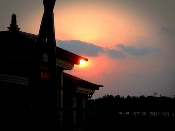 Silhouette built structure against sky during sunset