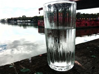 Reflection of trees on water against sky