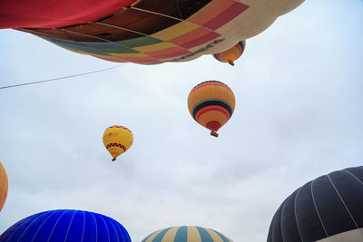 Low angle view of hot air balloons against sky