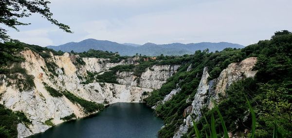 Panoramic view of river amidst mountains against sky