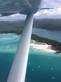 Aerial view of sea and mountains against sky