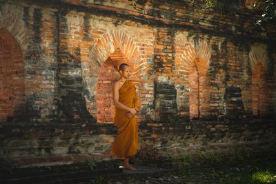 Man standing by temple against building