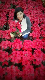 Portrait of woman holding pink flower