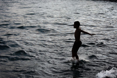 Full length of silhouette man in sea