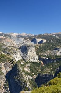 Scenic view of mountains against clear blue sky