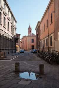 Street amidst buildings against sky in city
