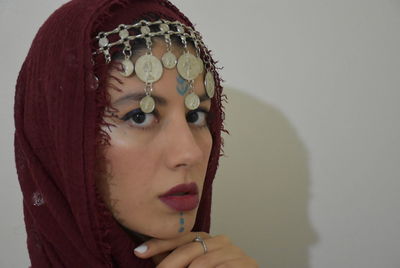 Close-up portrait of woman against wall