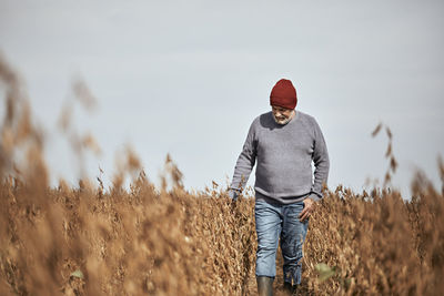 Man standing on field against sky