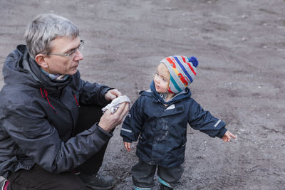 Grandfather and granddaughter outdoors during winter