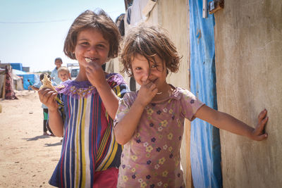 Portrait of smiling girls standing outdoors