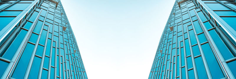 Low angle view of modern building against clear blue sky