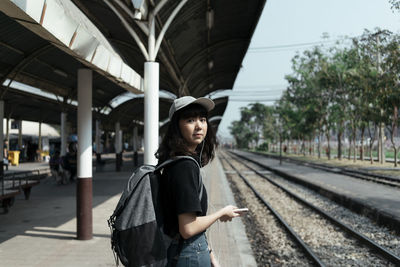 Full length of woman standing at railroad station