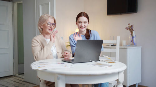 Businesswoman using laptop at home