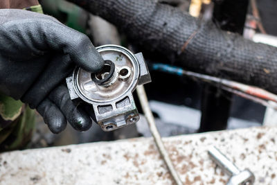 Close-up of man working on changing a fuel filter 