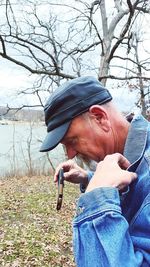 Woman standing on tree trunk