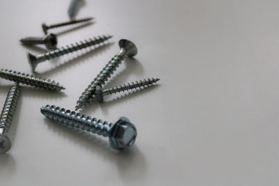 Close-up of screws on white background