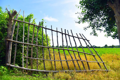 Fence on field against sky