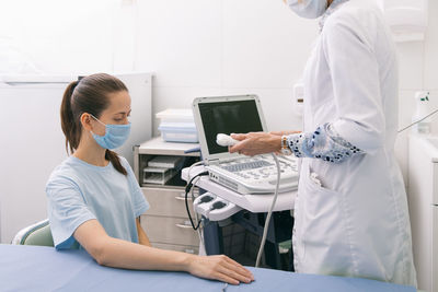 Midsection of doctor examining patient