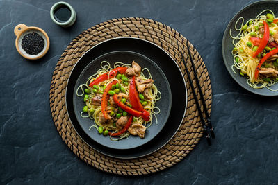 Chicken and edamame beans served with vermicelli noodles, ready for eating.