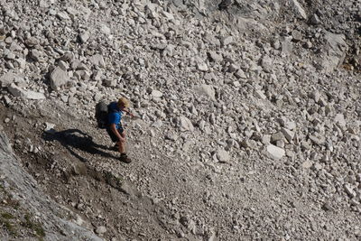 High angle view of man walking on stones