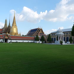 Facade of temple against cloudy sky