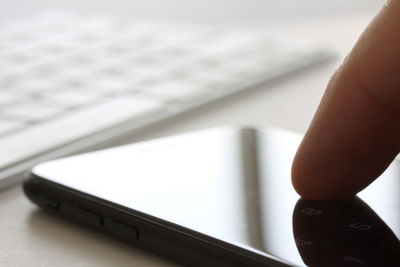 Close-up of hand holding mobile phone