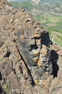 Close-up of rock on landscape against sky