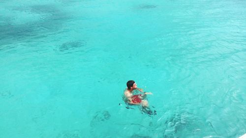 High angle view of man swimming in sea