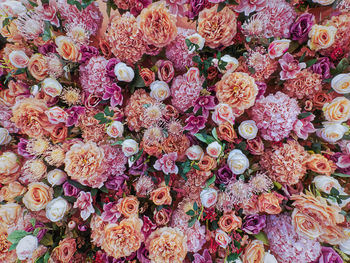 Full frame background of pink orange and white flowers decorated for celebration events