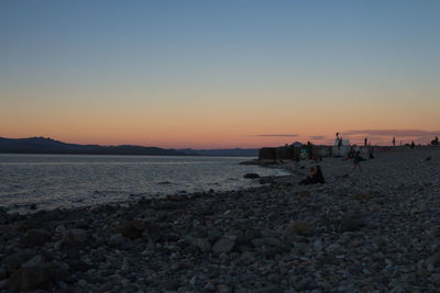 Scenic view of sea against clear sky during sunset