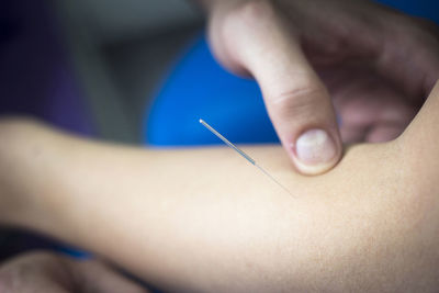 Close-up of needle in patient arm at hospital