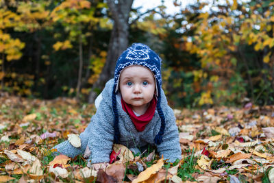 Portrait of cute girl in autumn leaves