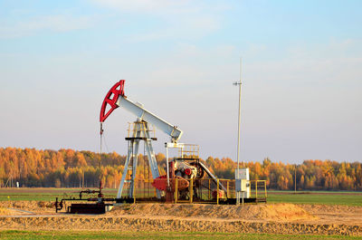 Traditional windmill on field against sky