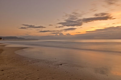 Scenic view of beach against sky during sunset