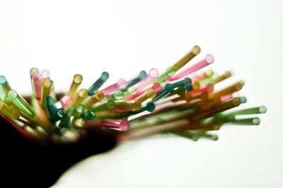 Close-up of colored pencils over white background