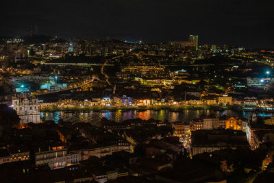 High angle view of illuminated buildings in city at night