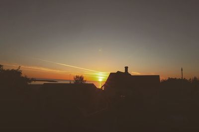 Silhouette of house at sunset