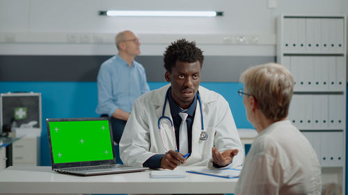 Doctor talking with patient in clinic