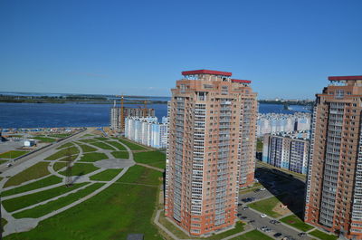 Panoramic view of buildings and sea against clear blue sky