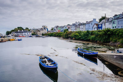 Boats moored at harbor