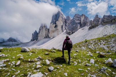 Woman on snowcapped mountains against sky