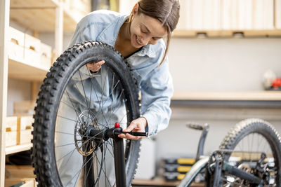 Woman looking at bicycle