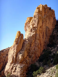 Low angle view of rock formation against sky