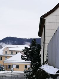 Houses against sky during winter