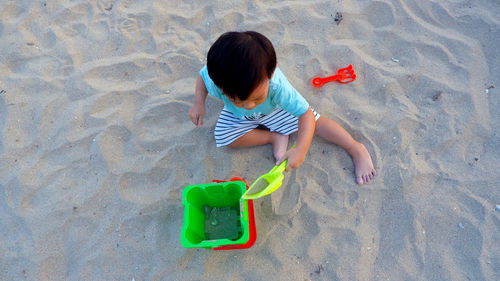 High angle view of boy playing in sea