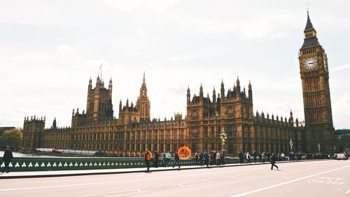 Westminster bridge by big ben against sky