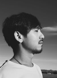 Close-up portrait of young man looking away