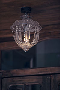 Low angle view of illuminated light bulb on table