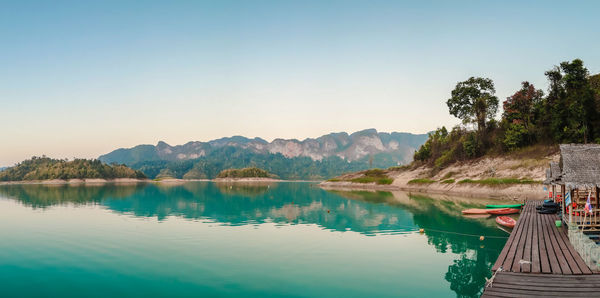 Scenic view of lake and mountains against clear sky