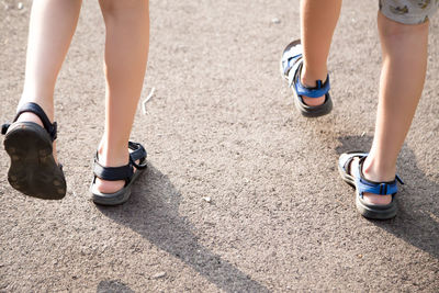 Low section of women wearing shoes